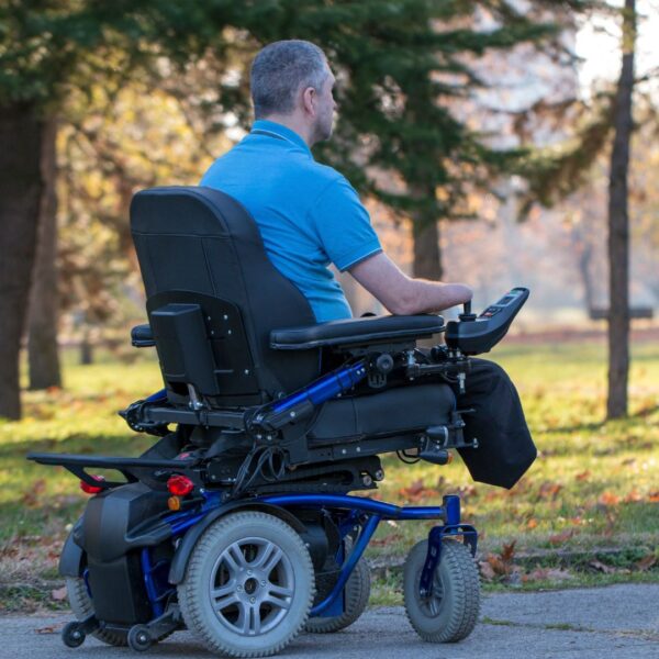 man in powered wheelchair outside