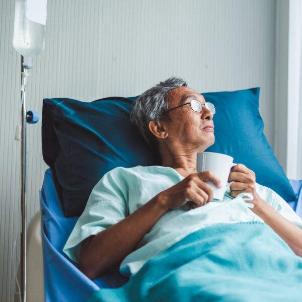 woman in hospital bed looking out window