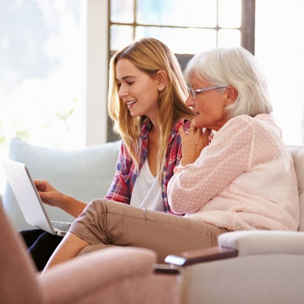 elderly woman and daughter using laptop