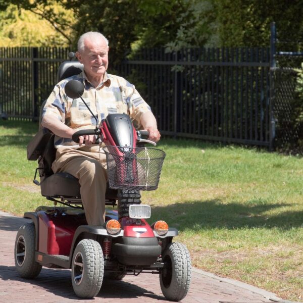 elderly man riding mobility scooter