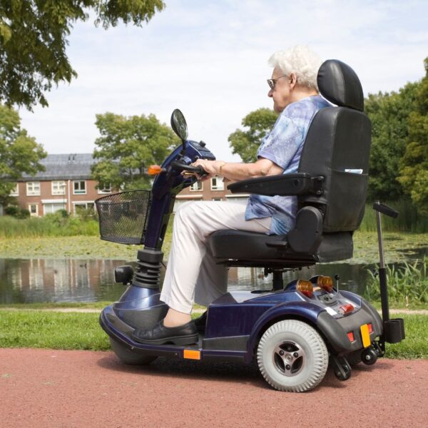 elderly woman riding mobility scooter