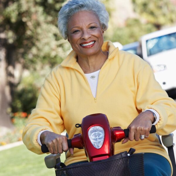 smiling woman riding mobility scooter