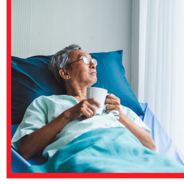 Man in hospital bed looking out a window