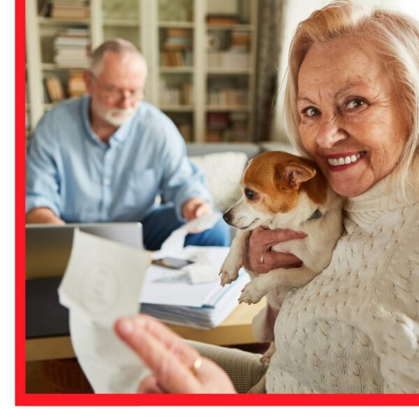 Older woman smiling while man works at computer