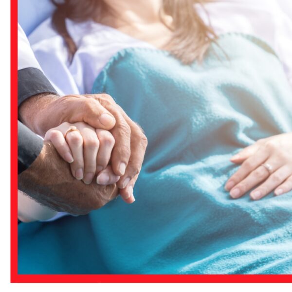 Woman in hospital bed holding a hand
