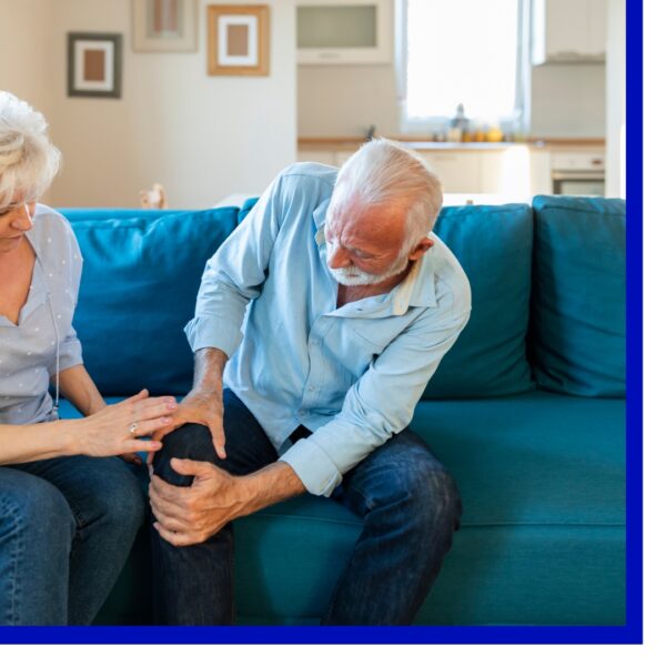 older man holding his knee