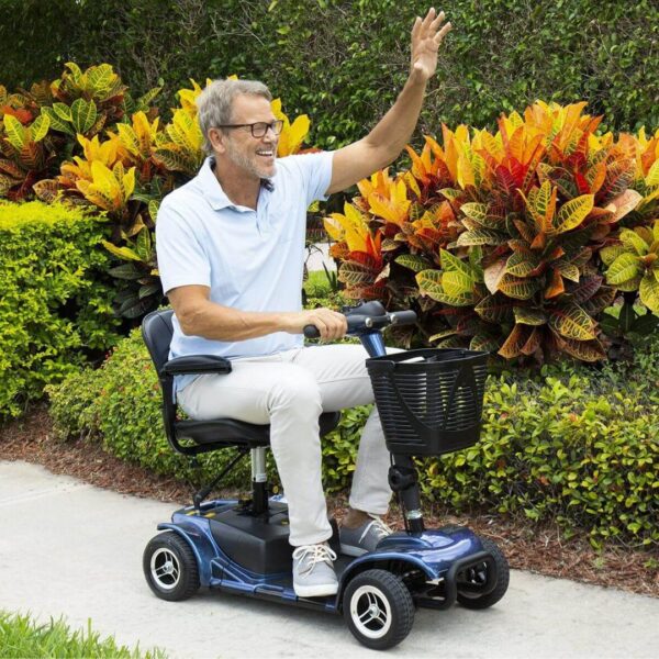 A man waving while riding a scooter